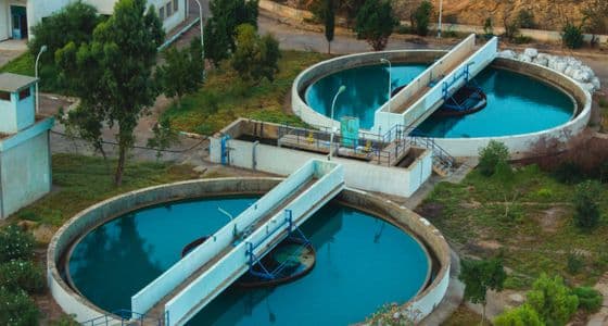 Circular sedimentation tanks at a water treatment facility seen from above